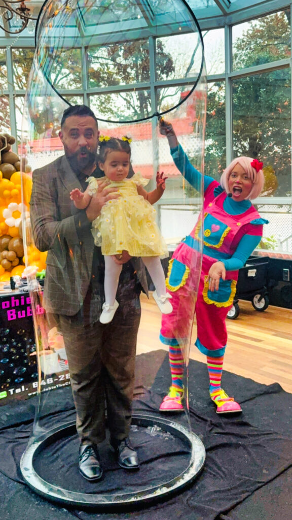 Bubble show entertainer creating giant bubble for kids at a North Jersey birthday party